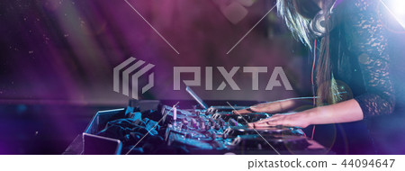 Dj mixes the track in the nightclub at a party Dj mixes the track in the nightclub at a party 44094647