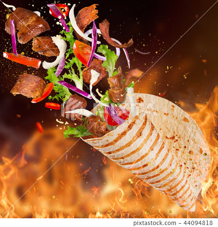 Turkish Kebab yufka with flying ingredients and flames. 44094818