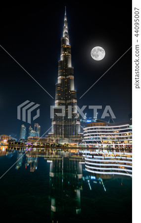 Dubai, United Arab Emirates - May 28, 2018 - Night view of Burj Khalifa - the highest building in the world - and lights reflection on the water. Dubai, United Arab Emirates - May 28, 2018 - Night view of Burj Khalifa - the highest building in the world - and lights reflection on the water. 44095007