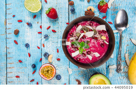 Smoothie bowl with fresh berries, nuts, seeds, fruit and vegetables. Smoothie bowl with fresh berries, nuts, seeds, fruit and vegetables. 44095019