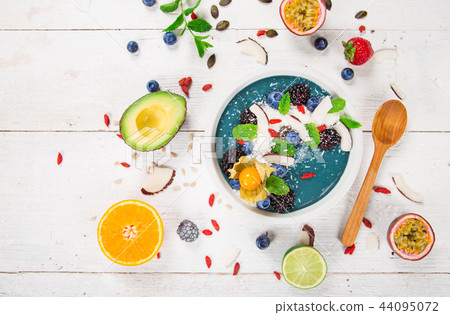 Smoothie bowl with fresh berries, nuts, seeds, fruit and vegetables. Smoothie bowl with fresh berries, nuts, seeds, fruit and vegetables. 44095072