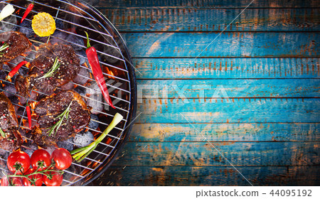 Barbecue grill with beef steaks, close-up. Barbecue grill with beef steaks, close-up. 44095192