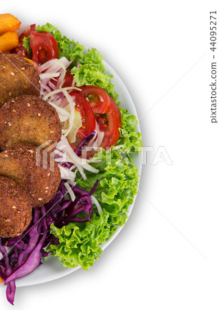 Falafel plate with fresh vegetables, hummus and french fries. 44095271