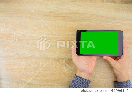 Businessman holding tablet with green screen. Businessman holding tablet with green screen. 44096343