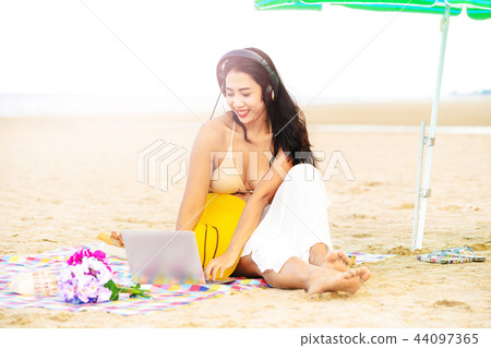 Plus size young woman sitting on the beach. Plus size young woman sitting on the beach. 44097365