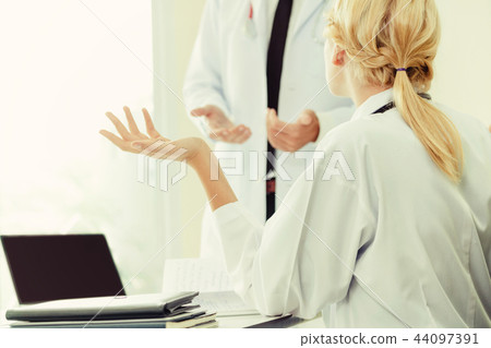 Female doctor at hospital talking to her partner. 44097391
