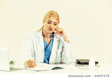 Doctor in hospital working on medical report. 44097479