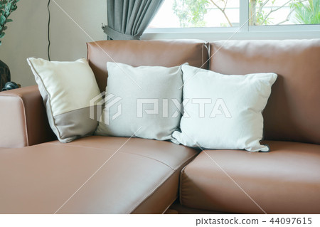 brown leather sofa with pillows in the living room brown leather sofa with pillows in the living room 44097615