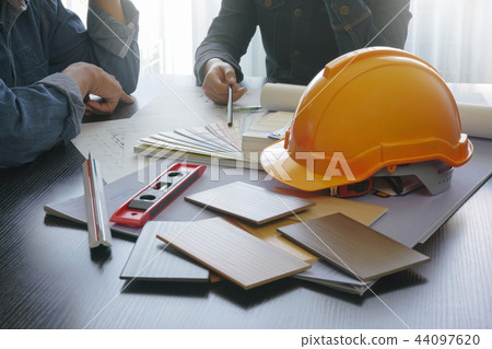 architect and engineer discussing on working table architect and engineer discussing on working table 44097620