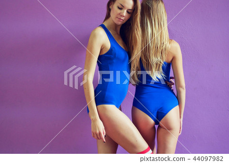 Two beautiful girls dance against wall Two beautiful girls dance against wall 44097982