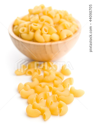 Uncooked elbow macaroni. Uncooked elbow macaroni. 44098705