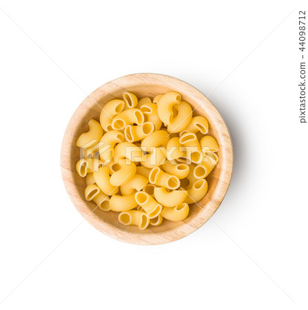Uncooked elbow macaroni. Uncooked elbow macaroni. 44098712