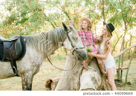 young girl with light hair with a little sister young girl with light hair with a little sister 44099669