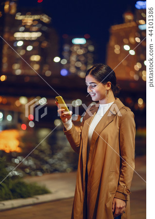 girl at night with phone 44101386