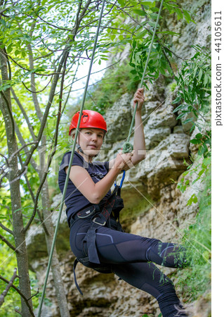 Photo of woman climber in red helmet on mountain Photo of woman climber in red helmet on mountain 44105611
