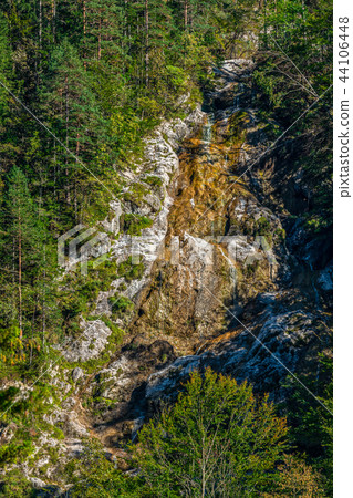 Creek flowing over rocks in mountains, small waterfall 44106448