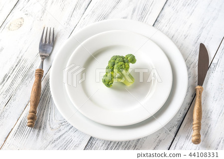 Fresh broccoli on the white plate Fresh broccoli on the white plate 44108331
