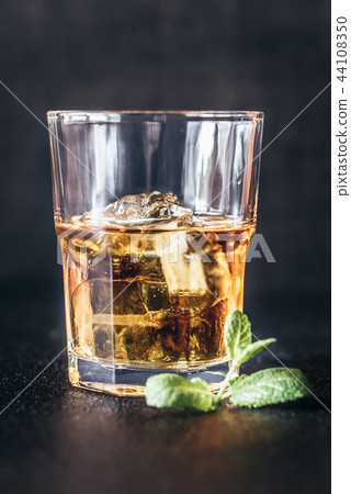 Glass of rum on the dark background 44108350