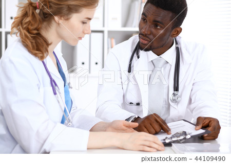 Happy african american male doctor  with medical staff at the hospital. Medicine concept 44109490