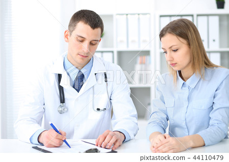 Doctor and  patient  sitting at the desk. Medicine and health care concept 44110479