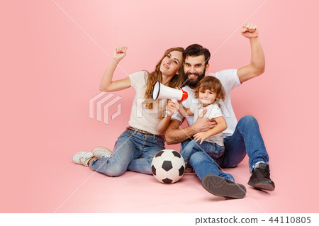 happy father and son playing together with soccer ball on pink happy father and son playing together with soccer ball on pink 44110805