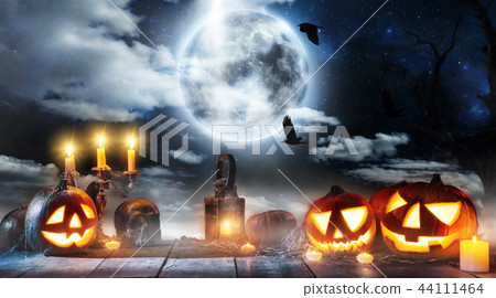 Spooky halloween pumpkin placed on wooden planks 44111464