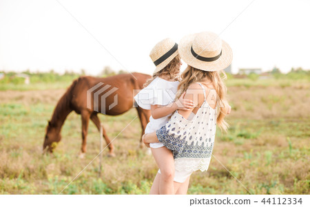 young girl with light hair with a little sister young girl with light hair with a little sister 44112334