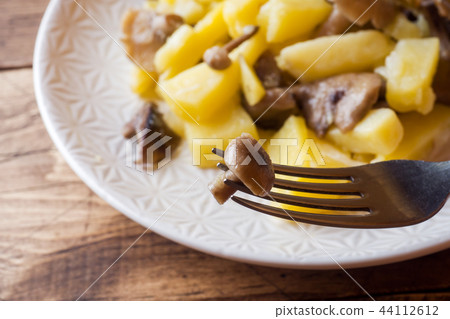 Fried potatoes with mushrooms and onions. Fried potatoes with mushrooms and onions. 44112612