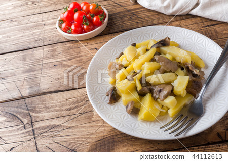 Fried potatoes with mushrooms and onions. Fried potatoes with mushrooms and onions. 44112613
