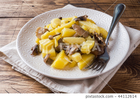 Fried potatoes with mushrooms and onions. Fried potatoes with mushrooms and onions. 44112614