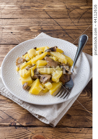 Fried potatoes with mushrooms and onions. 44112616
