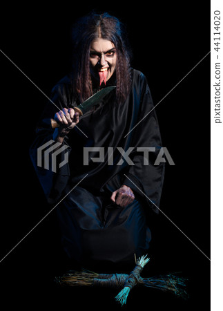 Witch isolated with voodoo doll version 44114020