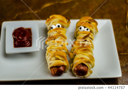 Sausage mummies in dough scary halloween food  44114787
