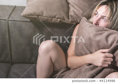 Scared woman under the pillow Scared woman under the pillow 44114996