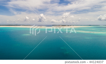 A coral reef island floating in the emerald green sea. Palau. (Aero shot with drone) A coral reef island floating in the emerald green sea. Palau. (Aero shot with drone) 44124837