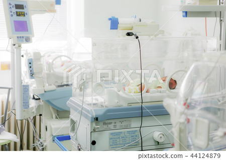 Newborn baby in hospital incubator Newborn baby in hospital incubator 44124879