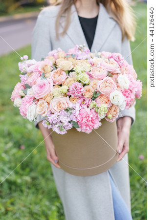 Beautiful spring bouquet in round box. Arrangement with various flowers. The concept of a flower 44126440