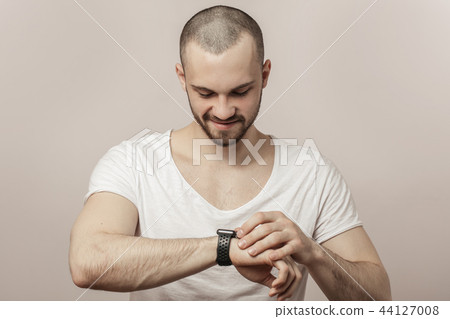 happy, joyful man is looking at the time 44127008