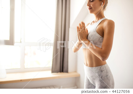 Young attractive Yoga teacher female greeting at the begining of practicing yoga 44127056