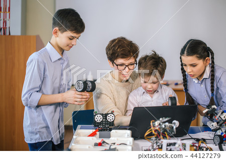 Happy children learn programming using laptops on extracurricular classes Happy children learn programming using laptops on extracurricular classes 44127279