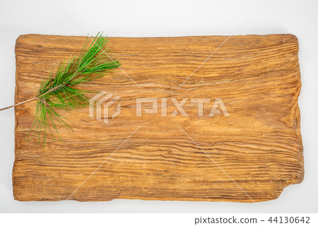 Natural brown wooden plank with pine needles, background 44130642