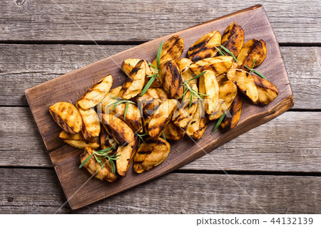 Homemade grilled potatoes with rosemary Homemade grilled potatoes with rosemary 44132139
