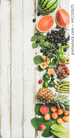 Seasonal fruit, vegetables and greens over wooden background, vertical composition Seasonal fruit, vegetables and greens over wooden background, vertical composition 44132625