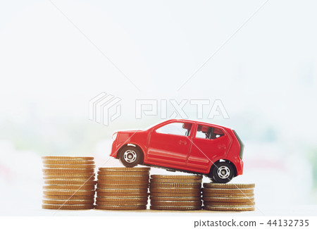 Little red car over a lot of money  44132735