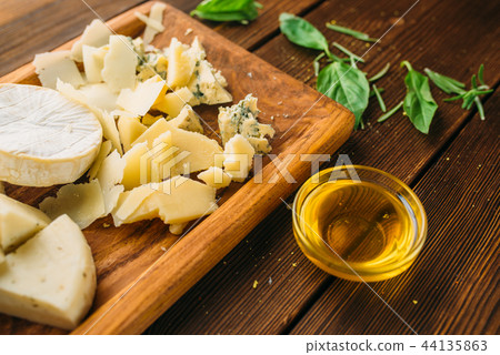 Cheese, oil and herb on wooden table closeup 44135863