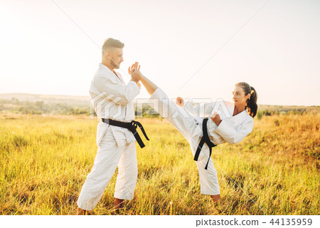 Female karate on training with male instructor Female karate on training with male instructor 44135959