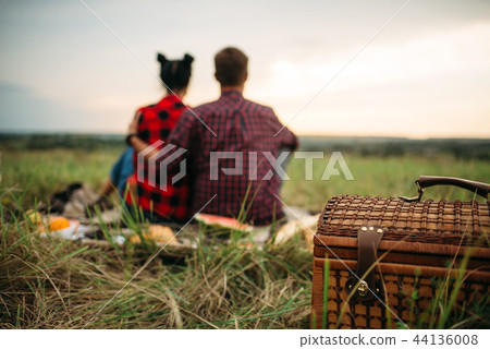 Basket, love couple sitting on plaid, picnic 44136008