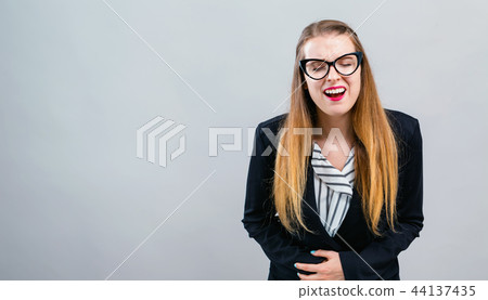 Young woman suffering from stomach pain 44137435