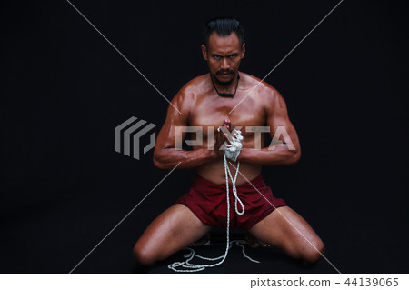 Muscular Man displays Thai Boxing or Muay Thai 44139065