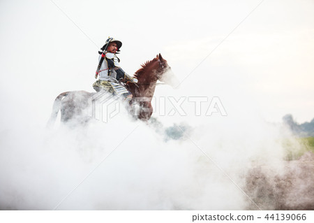 Asian Warrior in traditional armor on horse in fog 44139066